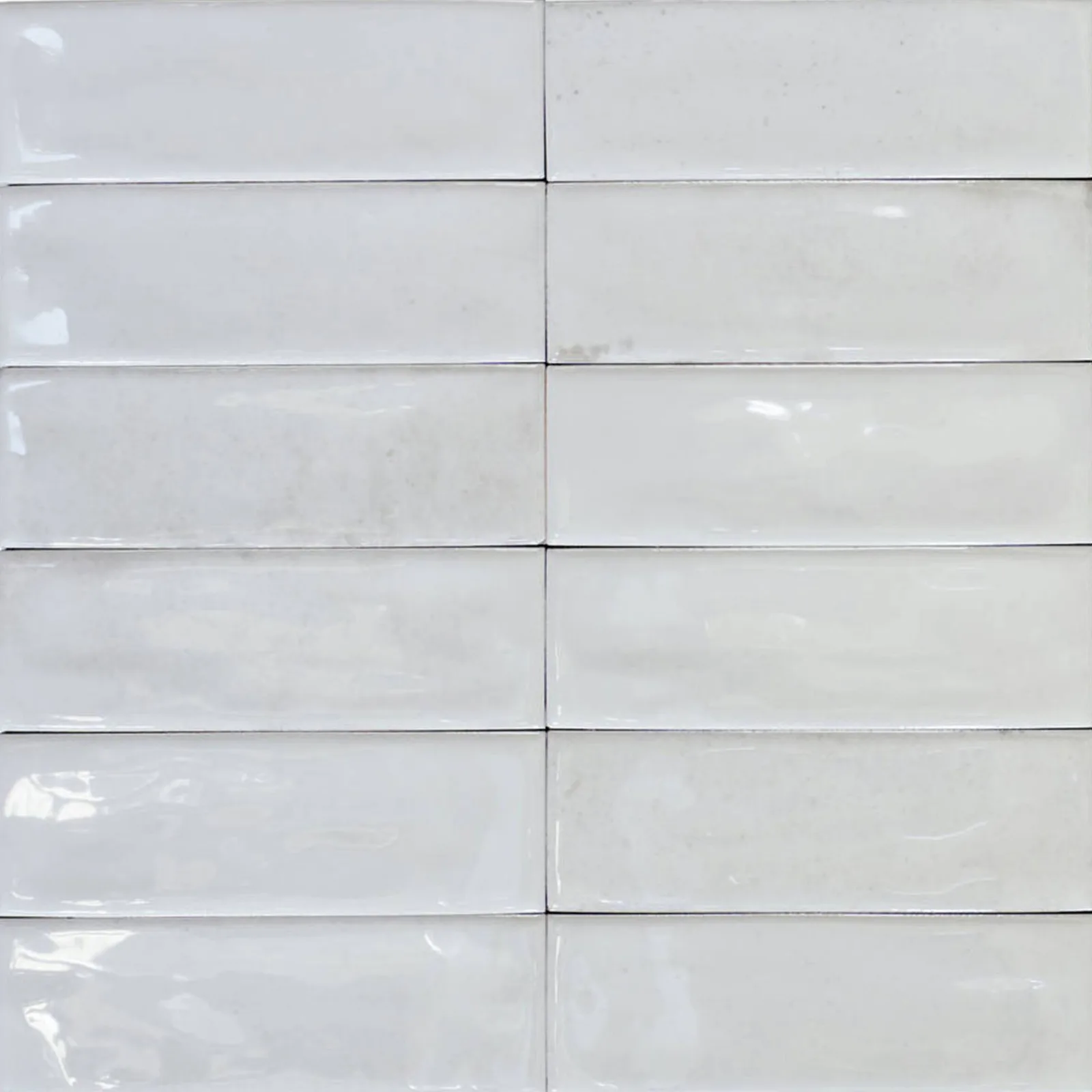 Calpe Porcelain Tile in white, greige, blue, and terra, glossy finish, 2x6 inches, 8.3mm thickness